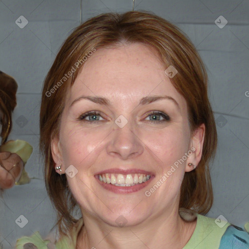 Joyful white adult female with medium  brown hair and blue eyes