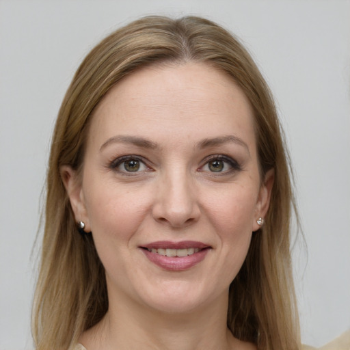 Joyful white young-adult female with long  brown hair and grey eyes