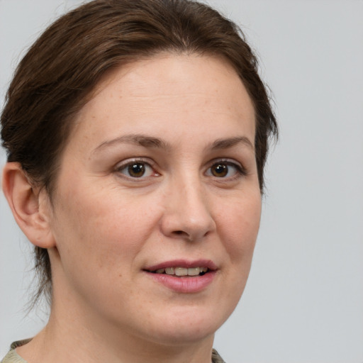 Joyful white adult female with medium  brown hair and brown eyes