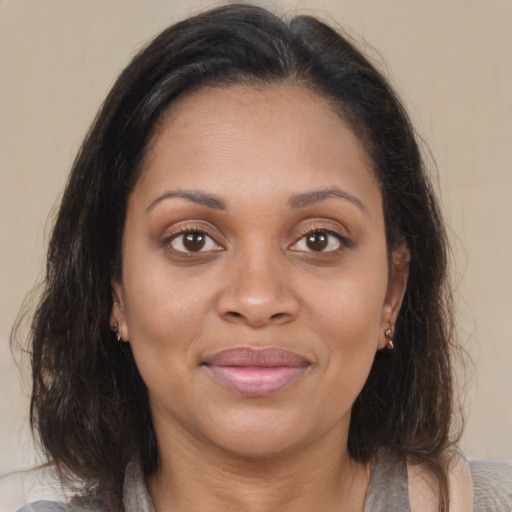 Joyful latino young-adult female with medium  brown hair and brown eyes