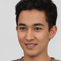 Joyful latino young-adult male with short  brown hair and brown eyes