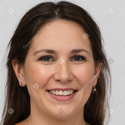 Joyful white adult female with long  brown hair and brown eyes