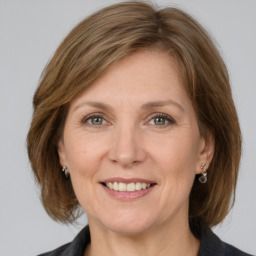 Joyful white adult female with medium  brown hair and grey eyes