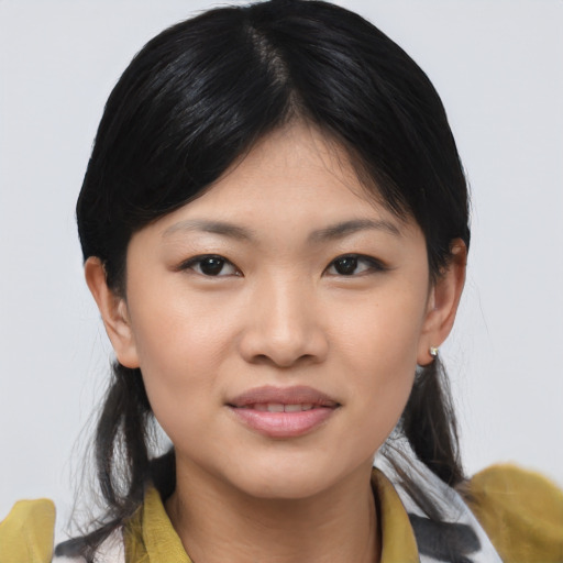 Joyful asian young-adult female with medium  black hair and brown eyes