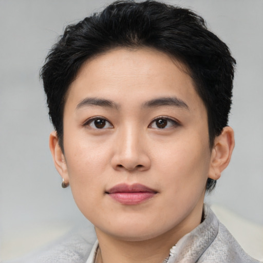 Joyful asian young-adult female with short  black hair and brown eyes