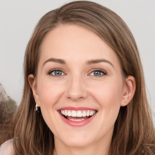 Joyful white young-adult female with long  brown hair and grey eyes