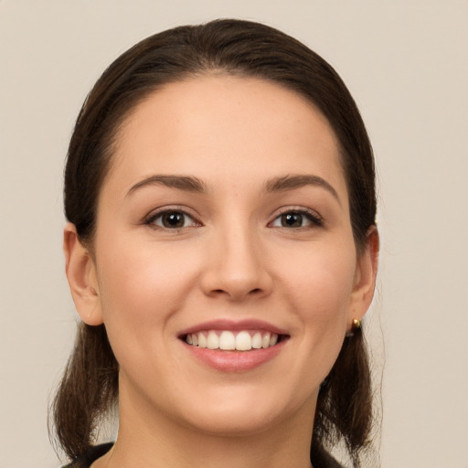 Joyful white young-adult female with long  brown hair and brown eyes