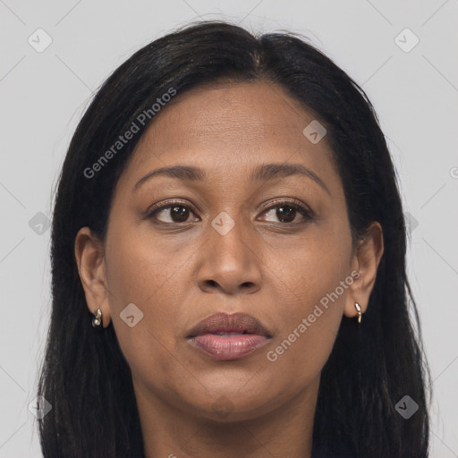 Joyful black adult female with long  brown hair and brown eyes