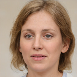 Joyful white young-adult female with medium  brown hair and blue eyes