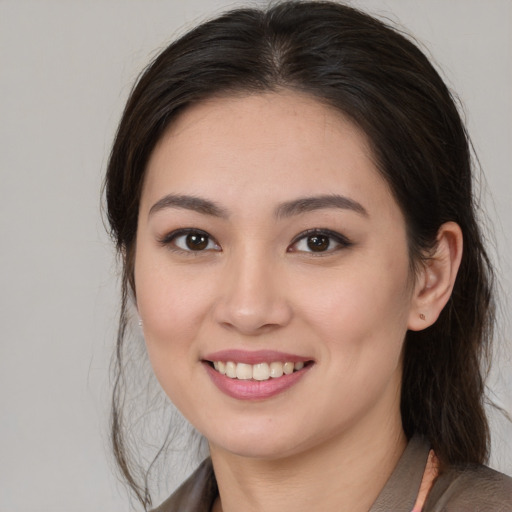 Joyful white young-adult female with medium  brown hair and brown eyes