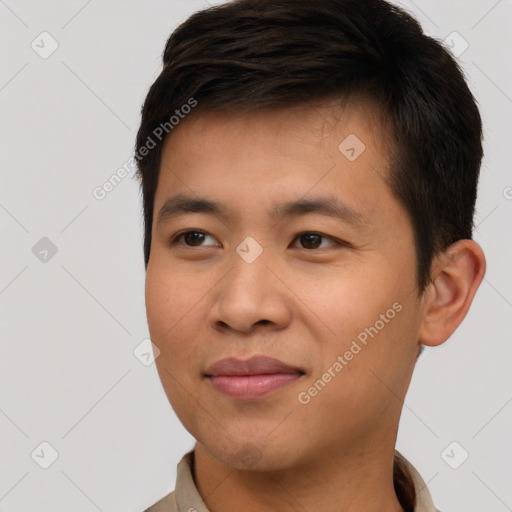 Joyful asian young-adult male with short  brown hair and brown eyes