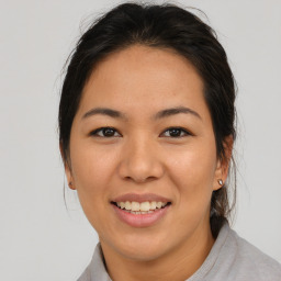 Joyful asian young-adult female with medium  brown hair and brown eyes