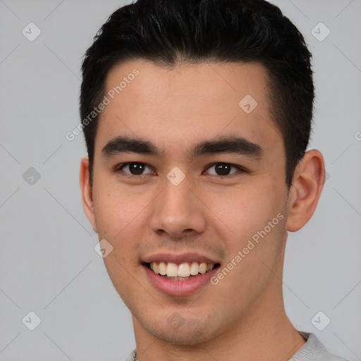 Joyful asian young-adult male with short  brown hair and brown eyes