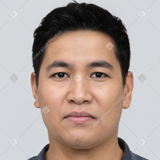 Joyful asian young-adult male with short  black hair and brown eyes