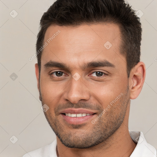 Joyful white young-adult male with short  brown hair and brown eyes