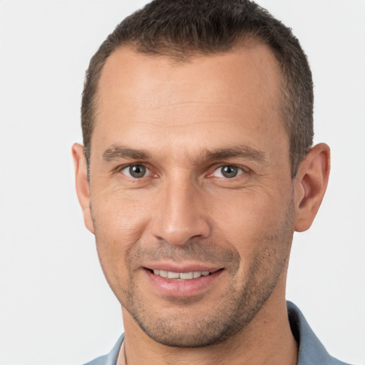 Joyful white adult male with short  brown hair and brown eyes