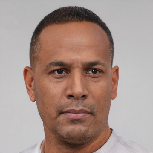 Neutral latino adult male with short  black hair and brown eyes