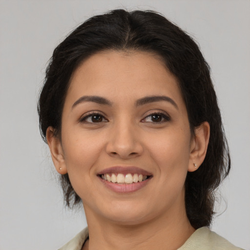 Joyful latino young-adult female with medium  brown hair and brown eyes