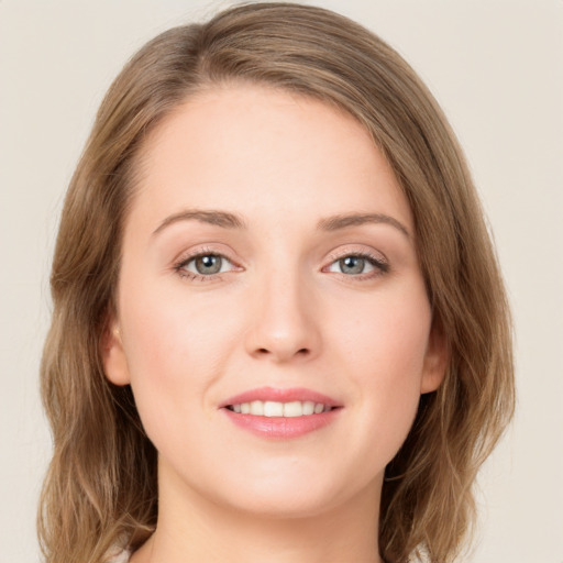 Joyful white young-adult female with medium  brown hair and green eyes