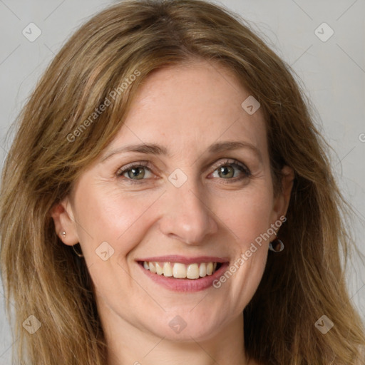 Joyful white young-adult female with long  brown hair and green eyes