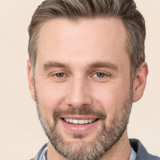 Joyful white adult male with short  brown hair and brown eyes