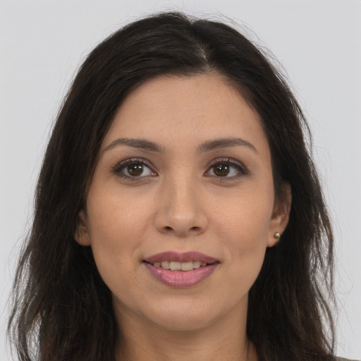 Joyful white young-adult female with long  brown hair and brown eyes