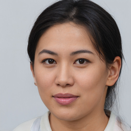 Joyful asian young-adult female with medium  brown hair and brown eyes