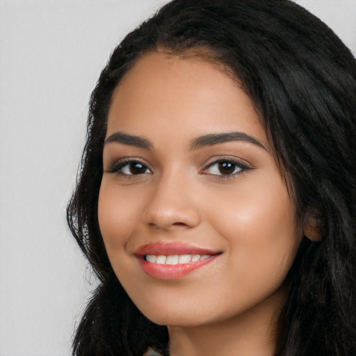 Joyful latino young-adult female with long  black hair and brown eyes