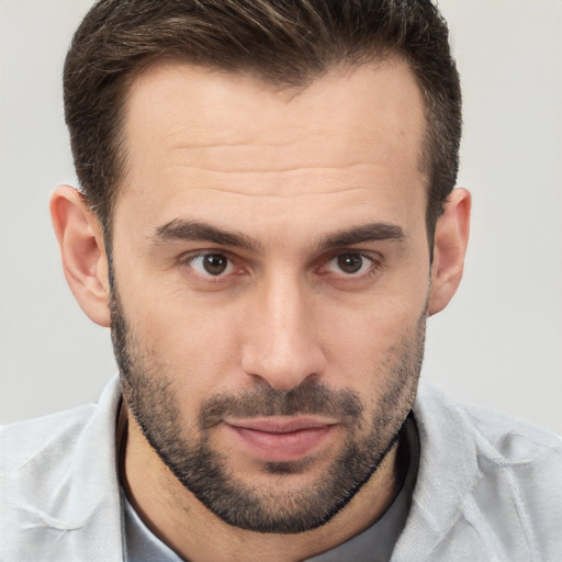 Joyful white young-adult male with short  brown hair and brown eyes