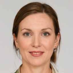 Joyful white adult female with medium  brown hair and grey eyes