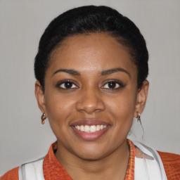 Joyful latino young-adult female with short  black hair and brown eyes