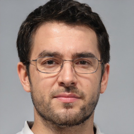 Joyful white adult male with short  brown hair and brown eyes