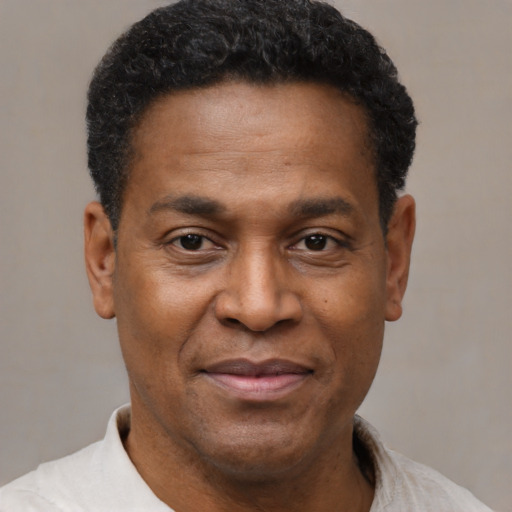 Joyful latino adult male with short  black hair and brown eyes