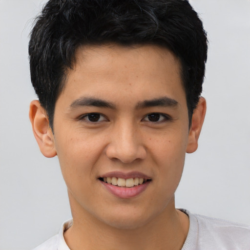 Joyful asian young-adult male with short  black hair and brown eyes