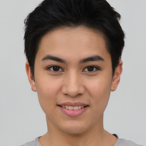 Joyful asian young-adult female with short  black hair and brown eyes