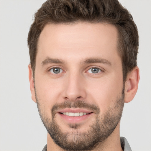 Joyful white young-adult male with short  brown hair and brown eyes