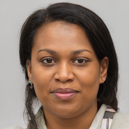 Joyful black young-adult female with medium  brown hair and brown eyes