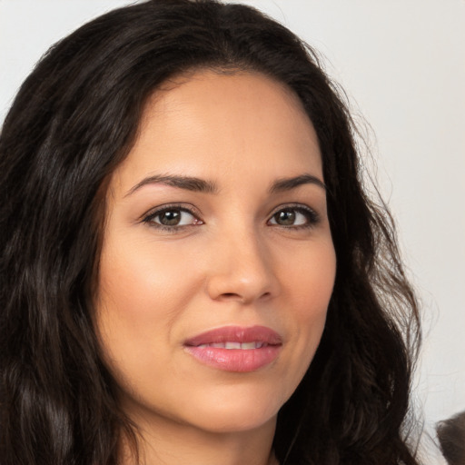 Joyful latino young-adult female with long  brown hair and brown eyes