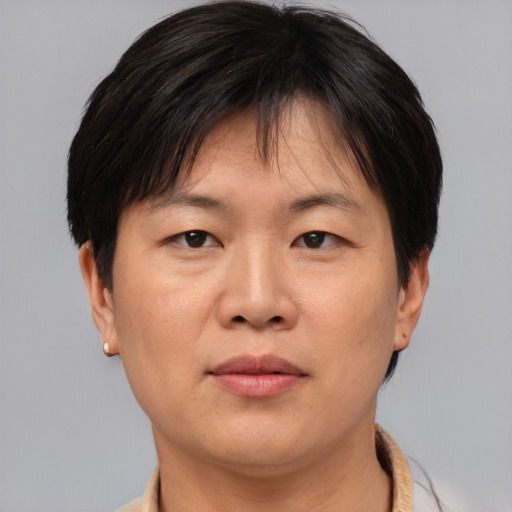 Joyful asian adult female with short  brown hair and brown eyes