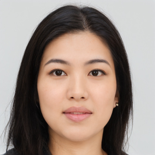 Joyful asian young-adult female with long  black hair and brown eyes