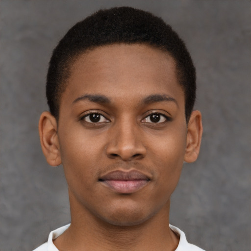 Joyful black young-adult male with short  brown hair and brown eyes