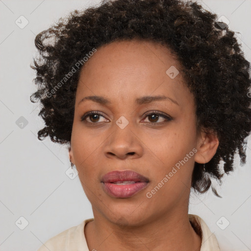 Joyful black adult female with short  brown hair and brown eyes