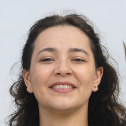 Joyful white adult female with long  brown hair and brown eyes