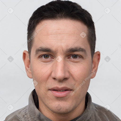 Joyful white adult male with short  brown hair and brown eyes