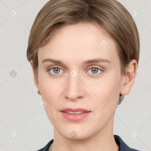 Joyful white young-adult female with short  brown hair and grey eyes