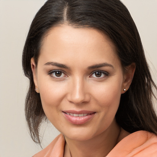 Joyful white young-adult female with long  brown hair and brown eyes