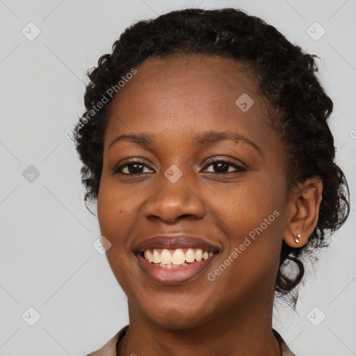 Joyful black young-adult female with long  brown hair and brown eyes