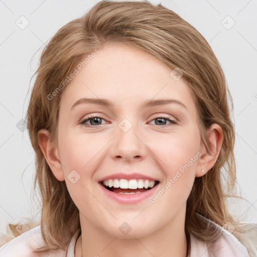 Joyful white young-adult female with medium  brown hair and blue eyes