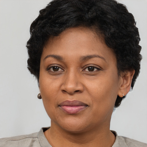 Joyful black adult female with short  brown hair and brown eyes