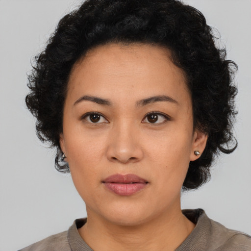 Neutral latino adult female with short  black hair and brown eyes
